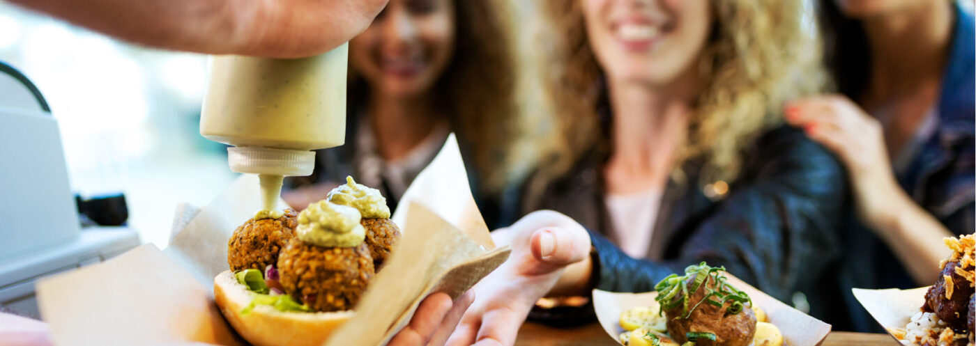 Portrait,Of,Three,Beautiful,Young,Women,Buying,Meatballs,On,A